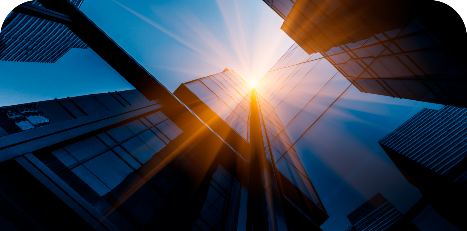 View looking up at a skyscraper against the sun